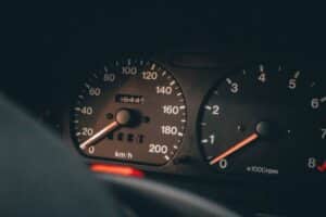 Detailed view of a car's speedometer and tachometer displaying speed and RPM.